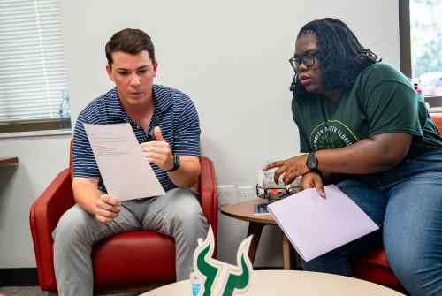 Coordinator with a student going through their resume