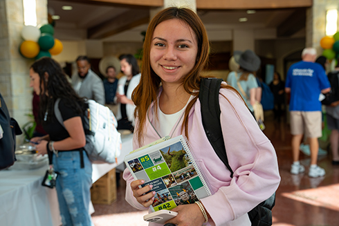 A students smiles in the rotunda