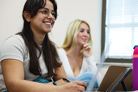 Two students smile in class